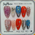 SkyMarie large press-on nails with glitter, butterfly, star, and swirl designs in pink, orange, blue, and silver.