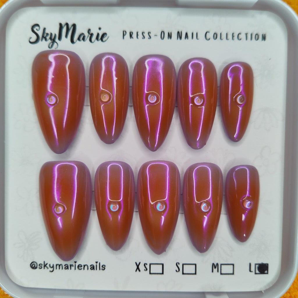SkyMarie iridescent orange-purple stiletto press-on nails with rhinestone accents, size Large.
